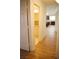 Hallway with wood floors leads to a bright kitchen and bathroom at 4417 Rita Dr, Las Vegas, NV 89121