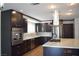 Elegant kitchen featuring stainless steel appliances, granite countertops, and dark wood cabinetry at 4417 Rita Dr, Las Vegas, NV 89121