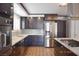 Elegant kitchen with stainless steel appliances, dark cabinets, and granite countertops at 4417 Rita Dr, Las Vegas, NV 89121