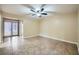 Spacious bedroom with tiled floors, ceiling fan, and access to the backyard through glass doors at 442 Republic St, Henderson, NV 89015