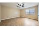 Bedroom featuring neutral walls, tiled floors, a window and a ceiling fan at 442 Republic St, Henderson, NV 89015