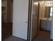 Hallway view of the bathroom with a sliding closet door, and kitchenette to the left at 4865 S Torrey Pines Dr # 106, Las Vegas, NV 89103