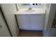 Bathroom sink with white cabinets and a large mirror above the sink at 4865 S Torrey Pines Dr # 106, Las Vegas, NV 89103