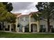 Inviting two-story condo building with well-maintained landscaping and exterior stairs at 4865 S Torrey Pines Dr # 106, Las Vegas, NV 89103