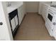 Narrow but functional kitchen with white cabinets and basic appliances at 4865 S Torrey Pines Dr # 106, Las Vegas, NV 89103