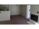 Open-concept floor plan with a fireplace, kitchen bar, and a doorway to the bathroom at 4865 S Torrey Pines Dr # 106, Las Vegas, NV 89103
