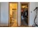 Hallway view into bathroom with glass shower door and walk-in closet with shelving at 5016 Roswell St, Las Vegas, NV 89120