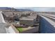 Back of a two-story home showing desert landscaping, an artificial grass area, and a fenced yard at 5204 Sunstone Mesa Dr, Las Vegas, NV 89166