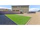Backyard with an artificial turf area, gravel landscaping and block wall fence at 5204 Sunstone Mesa Dr, Las Vegas, NV 89166