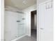 Modern bathroom boasting a glass-enclosed shower with built-in shelving and gray tile floor at 5204 Sunstone Mesa Dr, Las Vegas, NV 89166