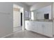 Bathroom view showcasing double sinks with granite counters, and doorway to bedroom at 5204 Sunstone Mesa Dr, Las Vegas, NV 89166