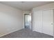 A neutral bedroom boasts a closet with sliding doors and plush carpeting at 5204 Sunstone Mesa Dr, Las Vegas, NV 89166