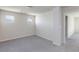 Bedroom with neutral carpet, two windows offering views, and an open doorway to another room at 5204 Sunstone Mesa Dr, Las Vegas, NV 89166