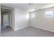 Carpeted bedroom with two windows, ceiling light, and a doorway to a hallway at 5204 Sunstone Mesa Dr, Las Vegas, NV 89166