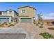 Two-story home featuring a two-car garage with a paved driveway at 5204 Sunstone Mesa Dr, Las Vegas, NV 89166