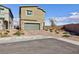 Two-story home featuring a two-car garage with a paved driveway at 5204 Sunstone Mesa Dr, Las Vegas, NV 89166
