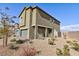 Exterior side view of a two-story home with a desert-landscaped yard at 5204 Sunstone Mesa Dr, Las Vegas, NV 89166