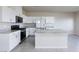 Modern kitchen features stainless steel appliances, granite countertops, and a center island at 5204 Sunstone Mesa Dr, Las Vegas, NV 89166