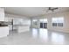 Spacious living room flows into the kitchen, featuring tiled floors and natural light at 5204 Sunstone Mesa Dr, Las Vegas, NV 89166