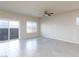Bright, tiled living room features a ceiling fan and sliding door to the backyard at 5204 Sunstone Mesa Dr, Las Vegas, NV 89166