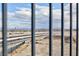 View through a metal fence of city and mountain landscape on a cloudy day at 5204 Sunstone Mesa Dr, Las Vegas, NV 89166