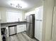 Bright kitchen featuring gray countertops, stainless appliances, and ample white cabinetry at 56 Belle Point Ave, Las Vegas, NV 89123