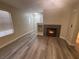 Bright living room features a fireplace and wood-look flooring at 56 Belle Point Ave, Las Vegas, NV 89123