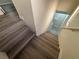 Neutral stairway featuring wood-look steps and white walls at 56 Belle Point Ave, Las Vegas, NV 89123