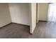 Modern living room with neutral walls and updated wood-look floors, with the hall on the right at 5709 Goldmount Ave, Las Vegas, NV 89107