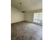 An empty living room with gray carpet and a ceiling fan at 5709 Goldmount Ave, Las Vegas, NV 89107