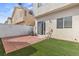 Backyard features a brick patio and well-manicured artificial grass at 5908 High Steed St # 102, Henderson, NV 89011