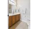 Bathroom with wood cabinets, a wide mirror and neutral paint at 5908 High Steed St # 102, Henderson, NV 89011