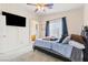Bright bedroom features a comfortable bed with a dark ceiling fan at 5908 High Steed St # 102, Henderson, NV 89011