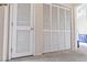 View of floor to ceiling closet with white louvered doors leading to a bedroom with natural light at 5908 High Steed St # 102, Henderson, NV 89011