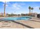 Community pool featuring a large pool with palm trees and landscaping at 5908 High Steed St # 102, Henderson, NV 89011