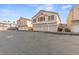Community townhomes with three car garages on a sunny day at 5908 High Steed St # 102, Henderson, NV 89011