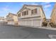 Charming townhome with three-car garage and neutral stucco exterior, offering ample parking and curb appeal at 5908 High Steed St # 102, Henderson, NV 89011