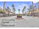 Community main entrance with palm trees and landscaping at 5908 High Steed St # 102, Henderson, NV 89011