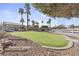 Enjoy the community putting green with manicured turf and mature palm trees at 5908 High Steed St # 102, Henderson, NV 89011