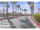 A community's second entrance with palm tree-lined roads and manicured greenery at 5908 High Steed St # 102, Henderson, NV 89011