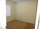 A carpeted bedroom with a window and blinds and neutral paint at 6143 Majestic Wind Ave, Las Vegas, NV 89122