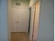 Hallway features white double doors for storage with tile flooring at 6143 Majestic Wind Ave, Las Vegas, NV 89122