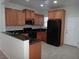 Modern kitchen with dark countertops and wood cabinets, featuring stainless steel appliances at 6143 Majestic Wind Ave, Las Vegas, NV 89122