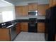 Well-equipped kitchen with stainless steel appliances and dark countertops at 6143 Majestic Wind Ave, Las Vegas, NV 89122
