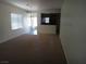 Open-concept living room with neutral tones and seamless transition to the kitchen at 6143 Majestic Wind Ave, Las Vegas, NV 89122