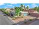 Aerial view of a modern property showcasing its clean lines, landscape, and secure gated driveway at 6325 Carmel Creek Ave, Las Vegas, NV 89139