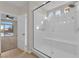 Walk-in shower with a seat and multiple shower heads sits adjacent to a large bedroom at 6325 Carmel Creek Ave, Las Vegas, NV 89139