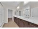 Bright primary bathroom with double sinks, a large mirror, and a walk-in shower with glass door at 6325 Carmel Creek Ave, Las Vegas, NV 89139