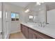 Bathroom features a dual sink vanity and a large mirror, perfect for convenience at 6325 Carmel Creek Ave, Las Vegas, NV 89139