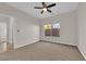 Carpeted bedroom with ceiling fan and natural light, offering a comfortable space at 6325 Carmel Creek Ave, Las Vegas, NV 89139